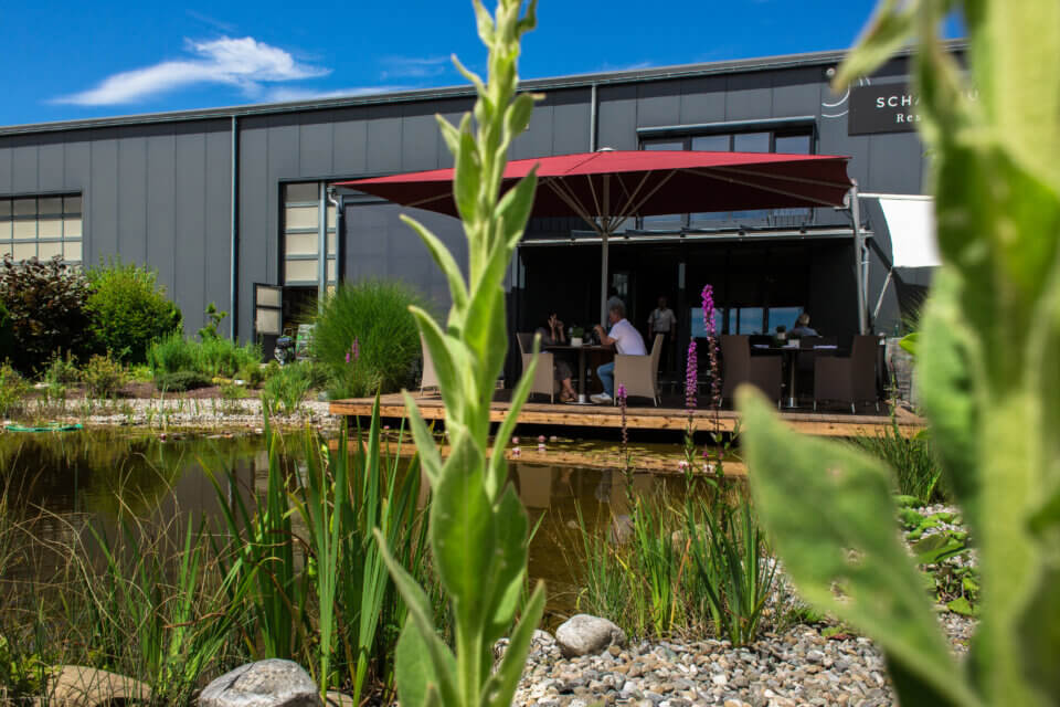Schattbuch-Sonnenterrasse am Koiteich im Grünen, fotografiert von der Gegenseite